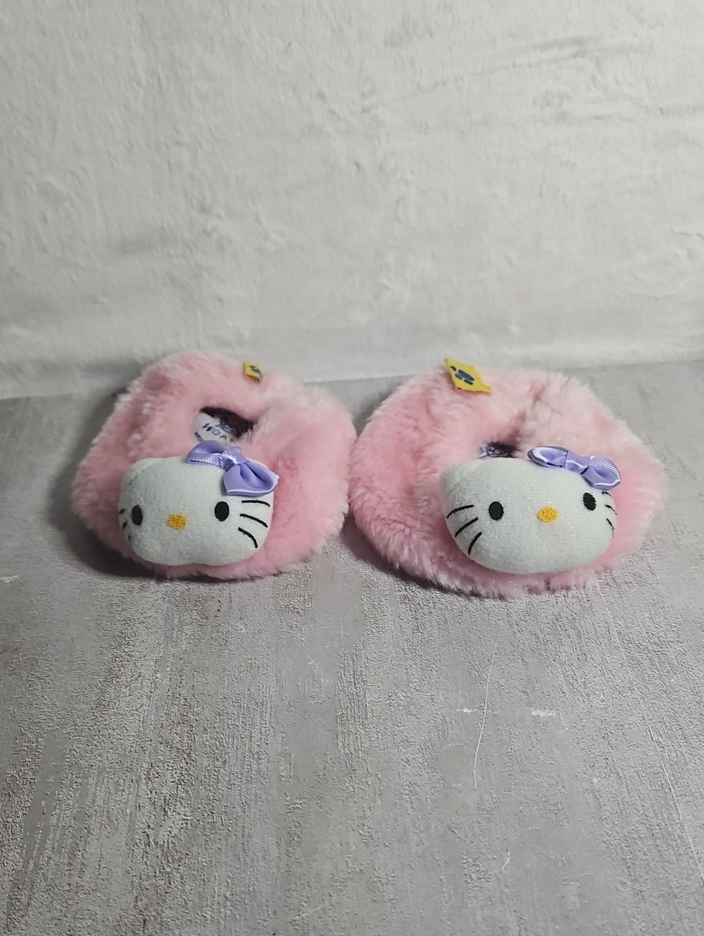 pair of pink fuzzy Build-A-Bear Workshop Hello Kitty plush